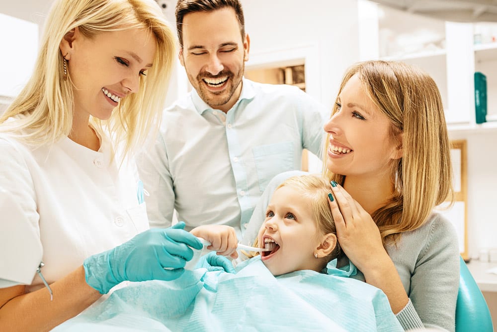 Dentist Treating Cute Blonde Child