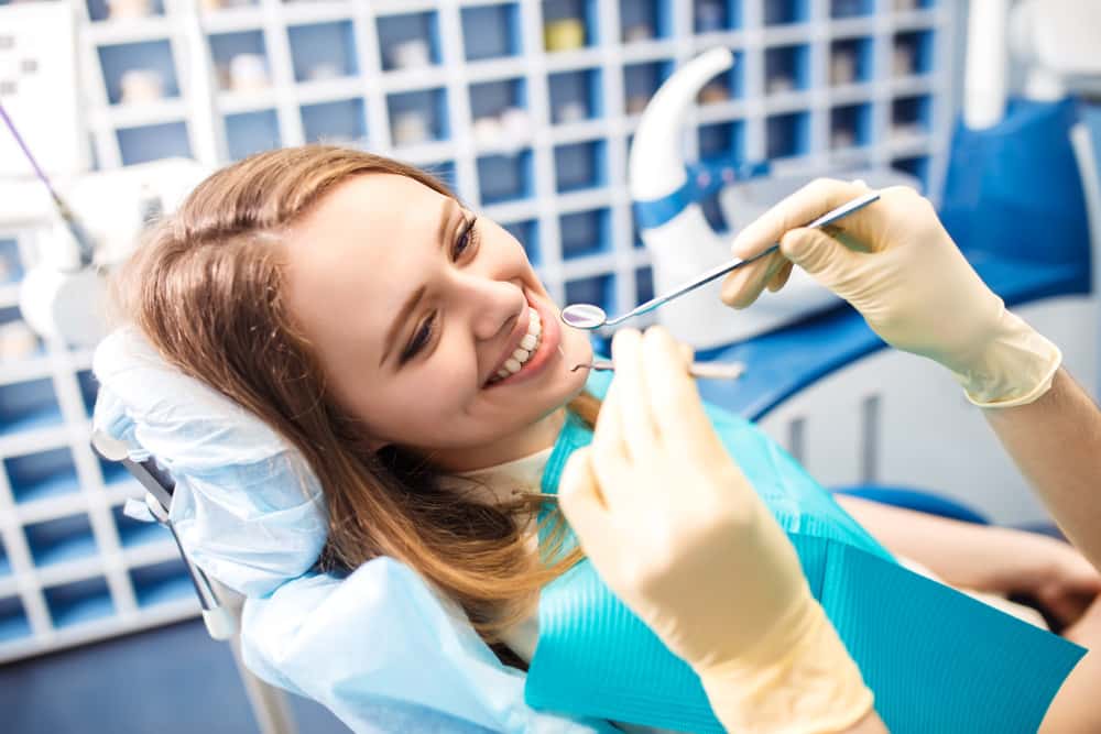Happy Young Woman At Dentist's Chair
