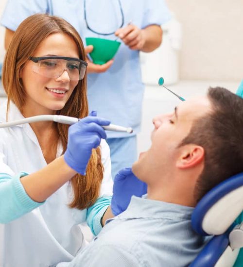 Female Dentists Examining Male Patient