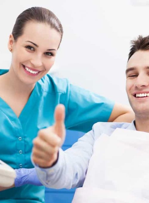 Man Giving Thumbs Up At Dentist Office
